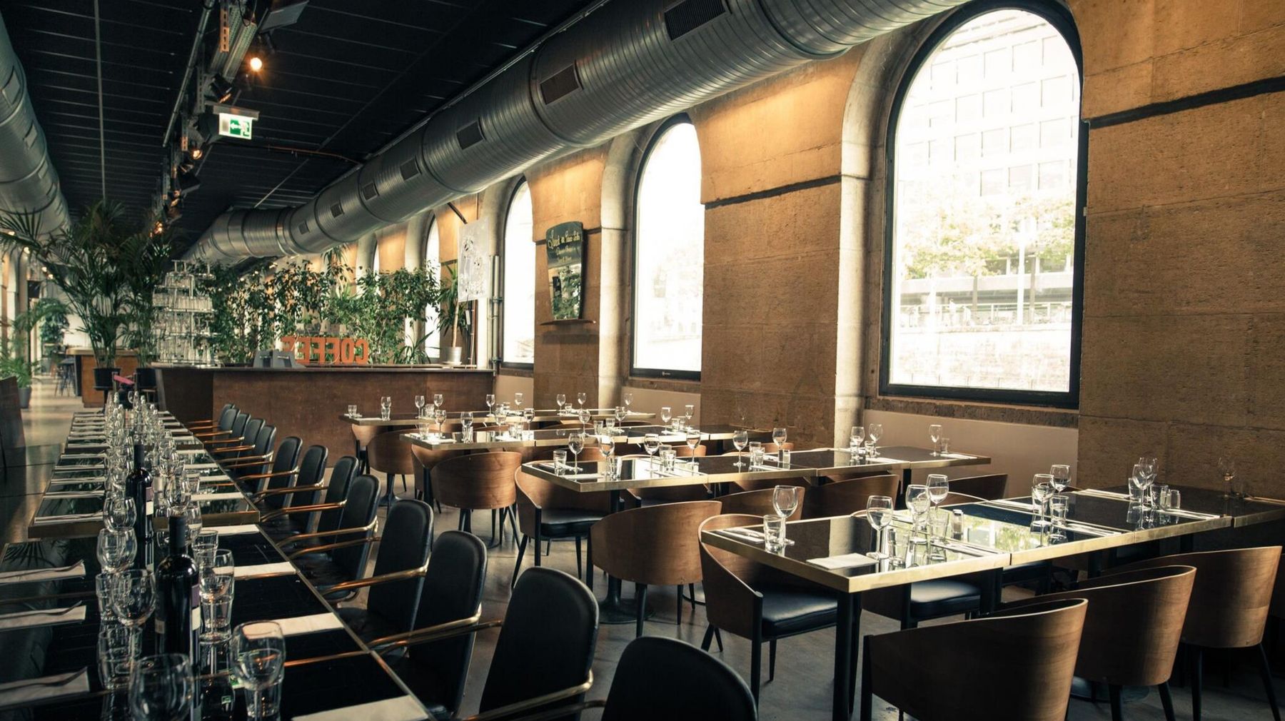 Les Halles de l'Île, Geneva: dining room with tall arched windows onto the Rhône