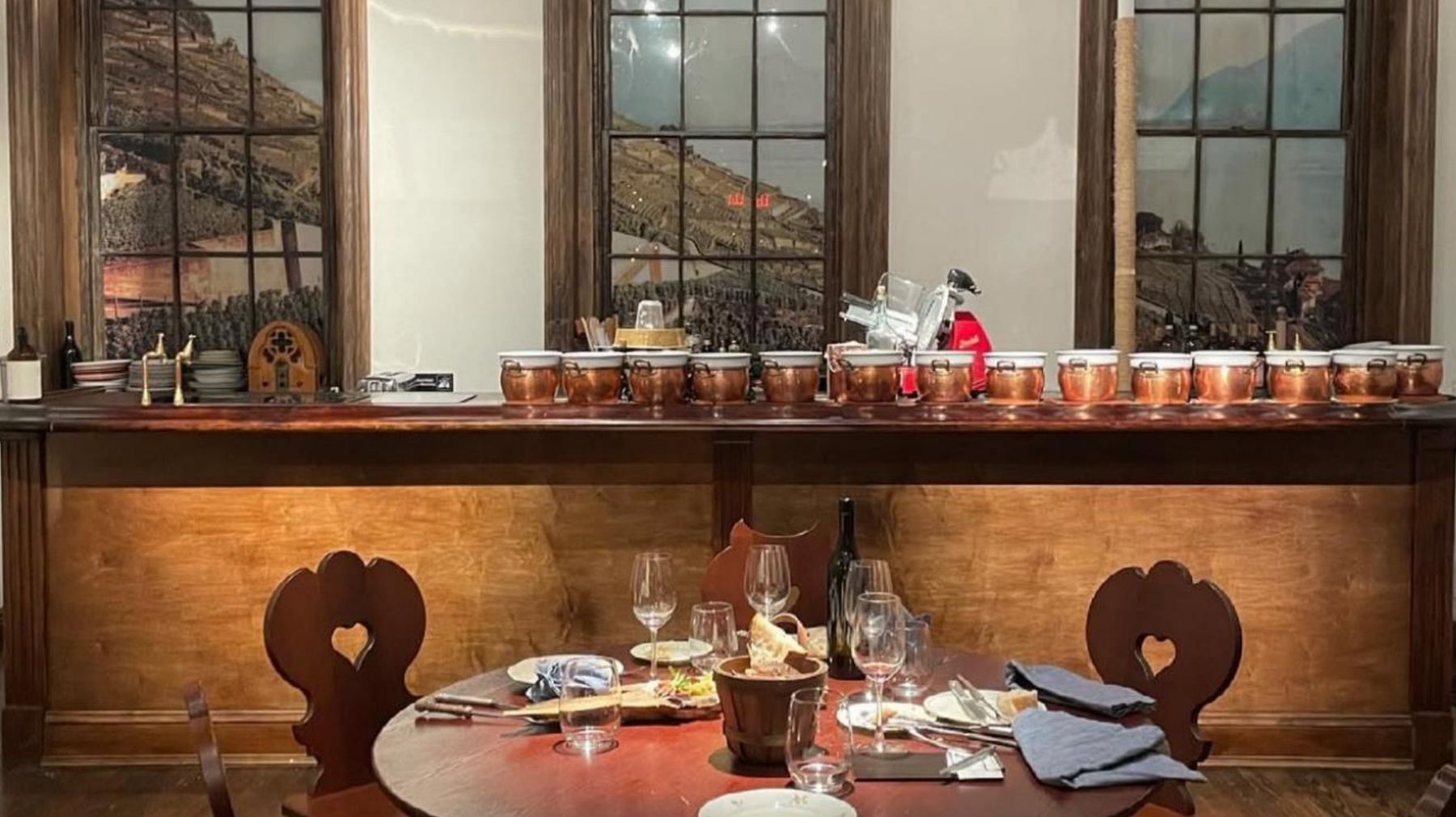 The Lavaux, New York: wooden bar with vineyard views and carved Alpine chairs